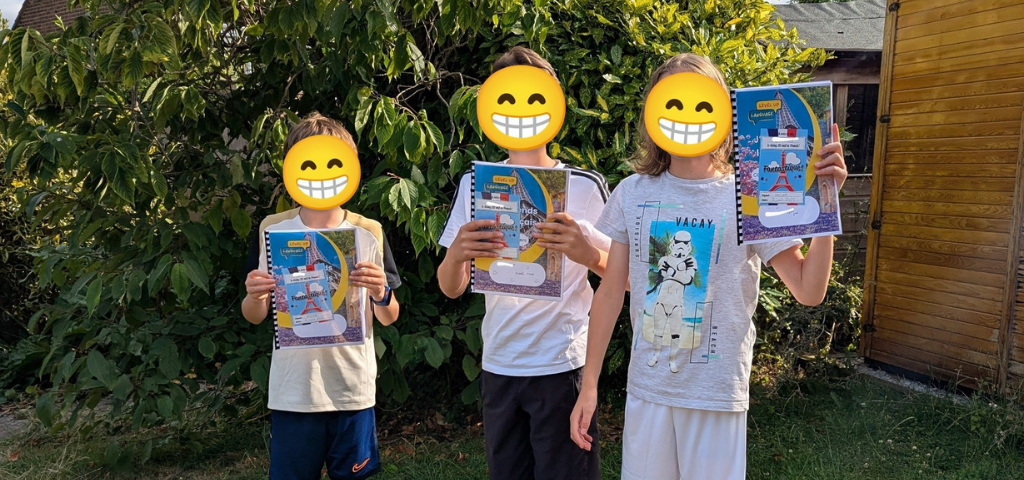 Children showing their French learning books